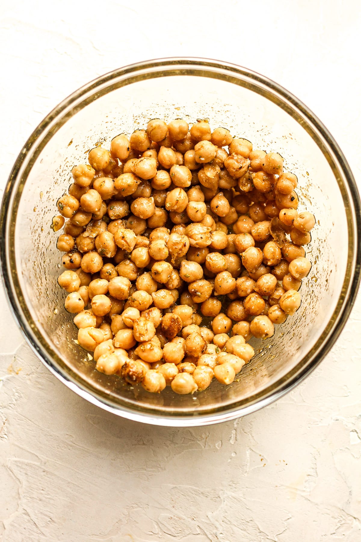 A bowl of the chickpeas after adding olive oil and seasonings.