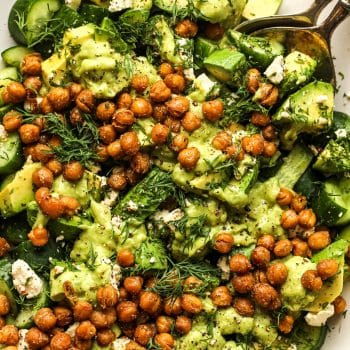 Closeup on the cucumber avocado salad with dressing and crispy chickpeas.