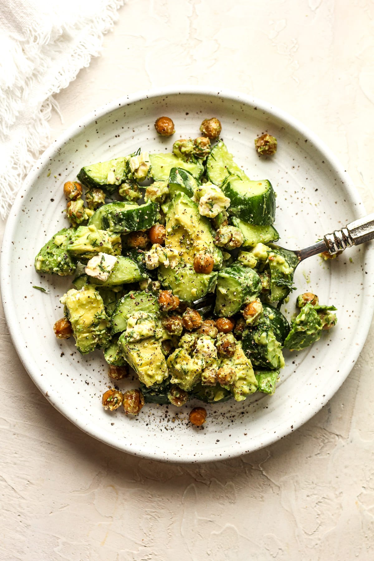 A serving plate of the cucumber avocado salad with crispy chickpeas.