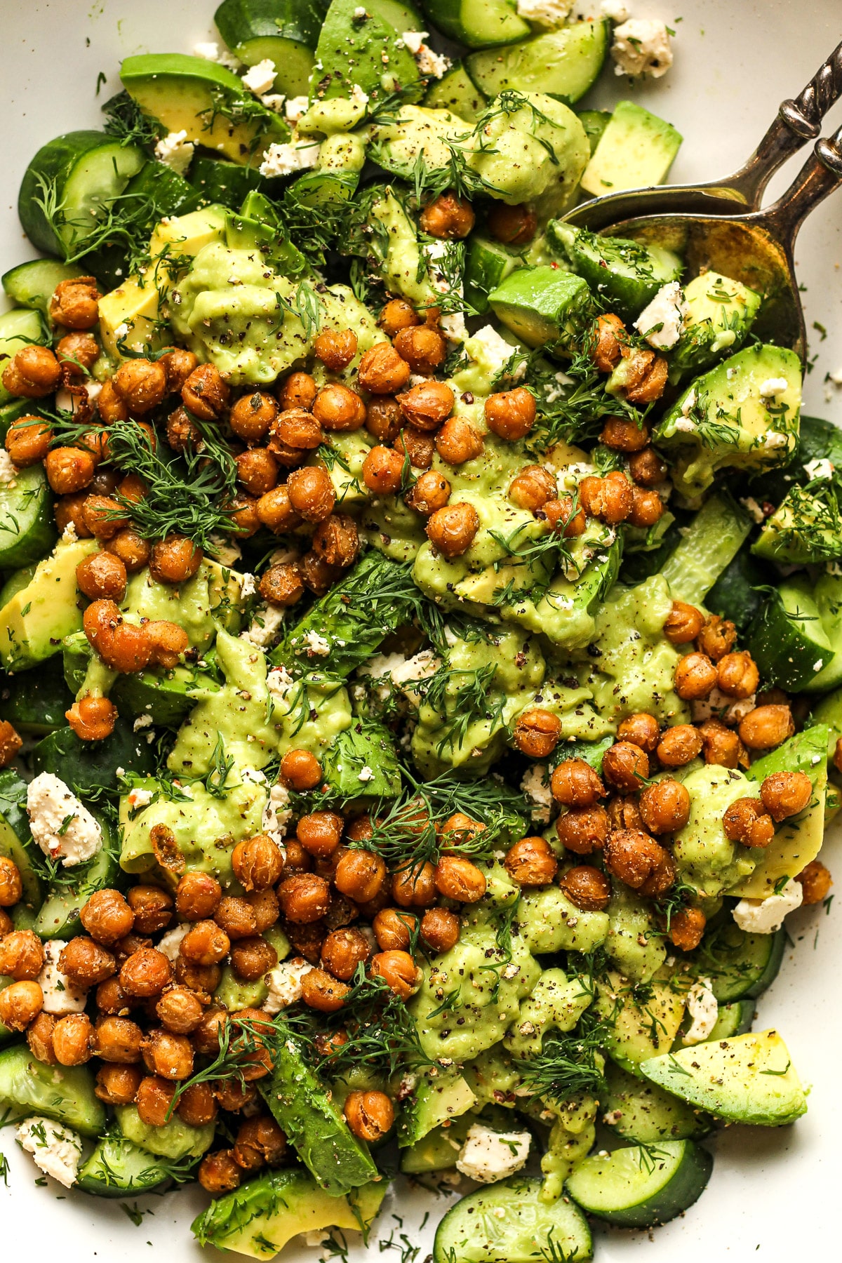 Closeup on the assembled salad with crispy chickpeas and dill on top.