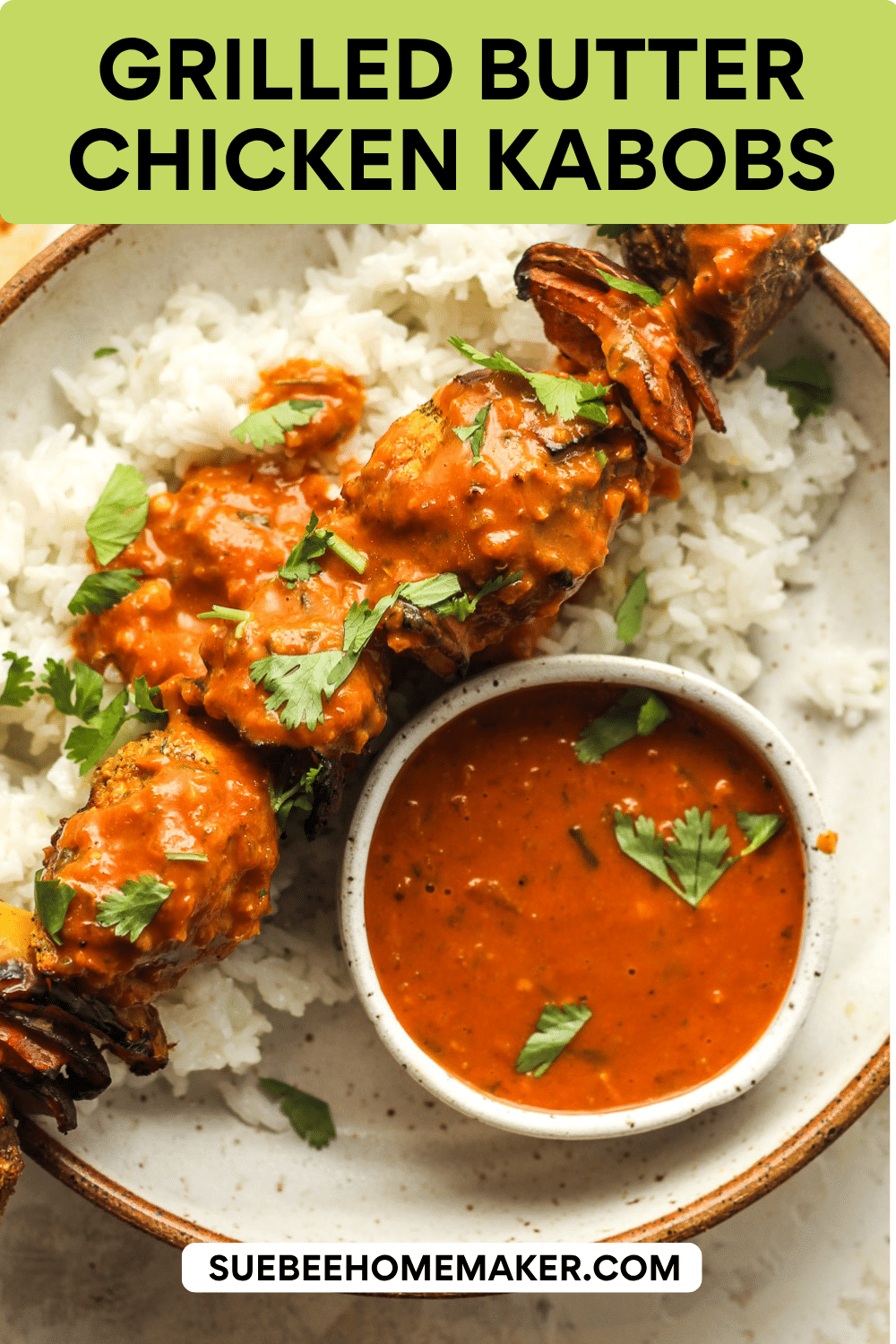 A grilled butter chicken kabob on white rice with some butter sauce.