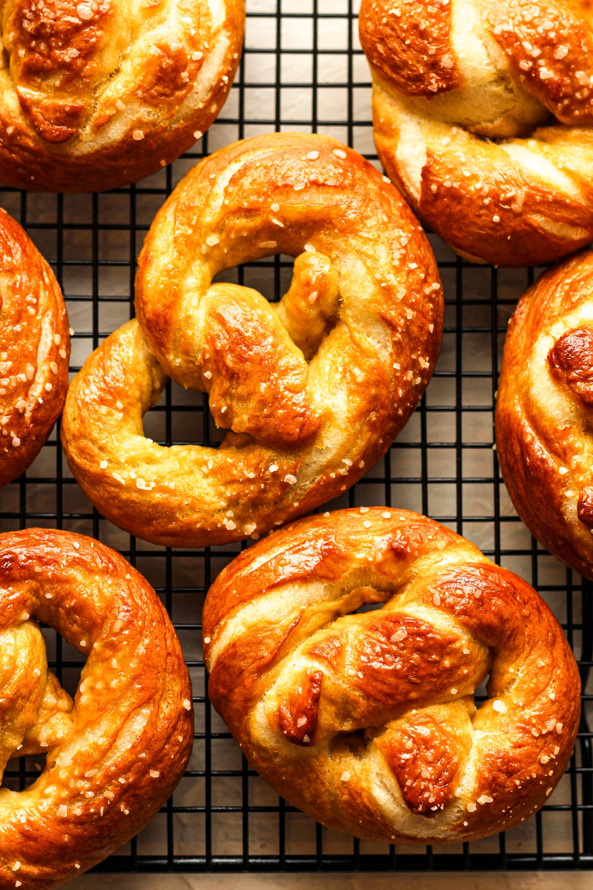 Closeup on some homemade soft pretzels on a wire rack.