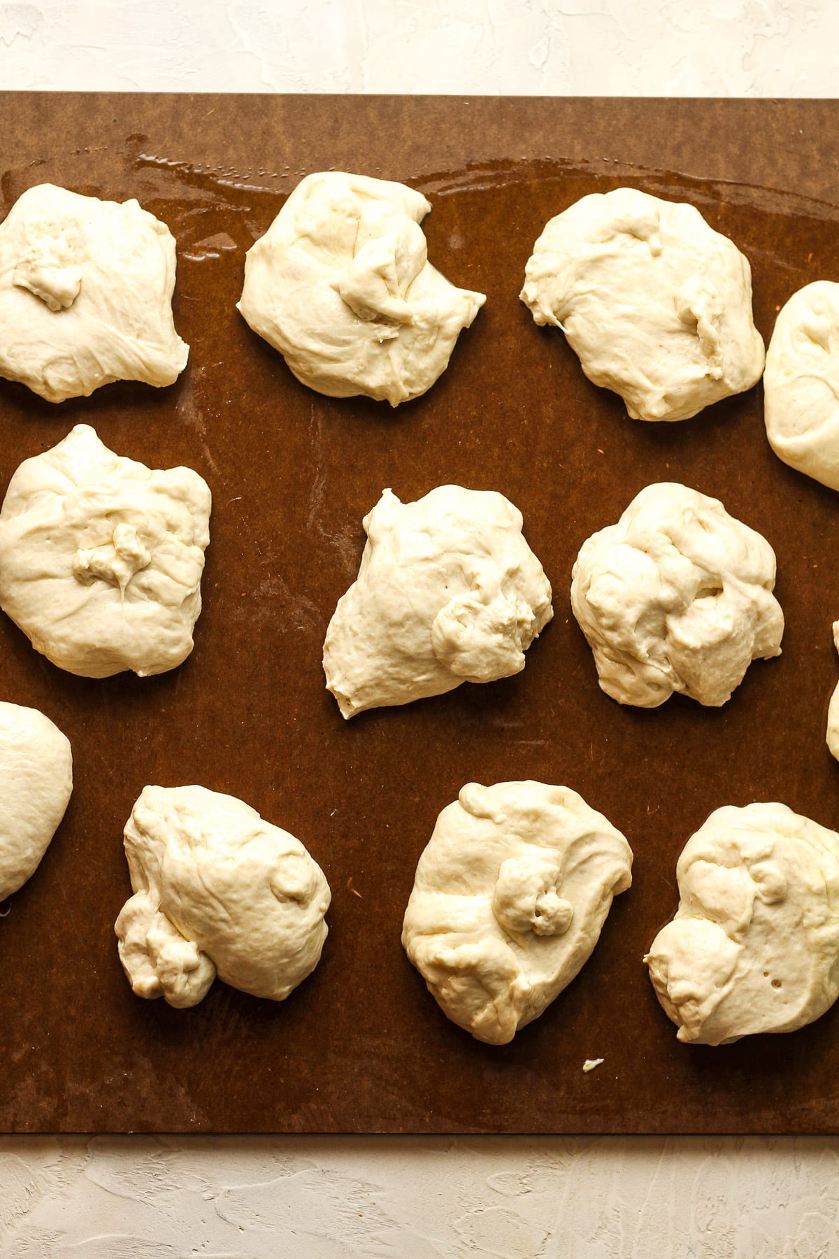 A large board with pieces of dough for pretzels.