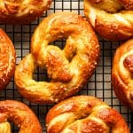 Closeup on soft pretzels on a wire rack.
