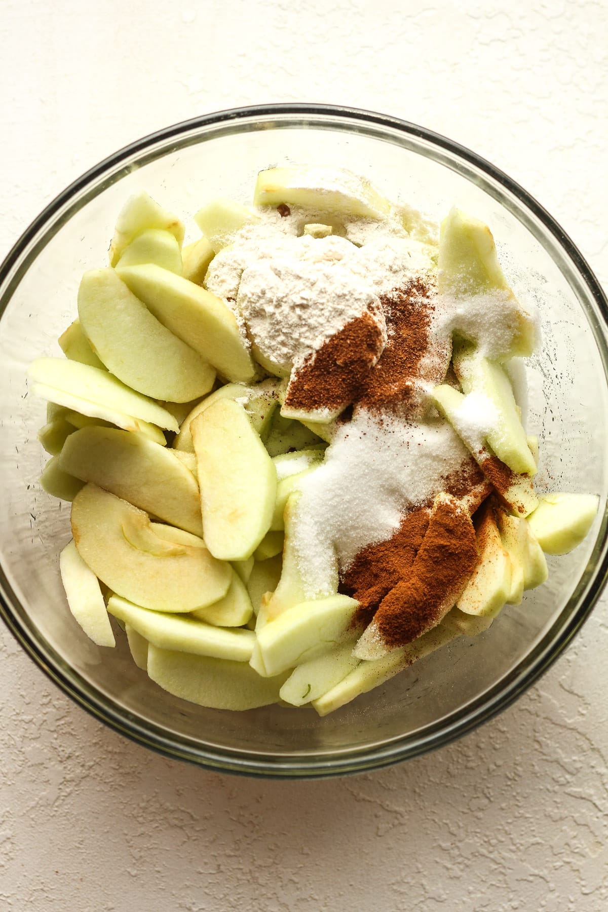 A bowl of apples with the ingredients on top.