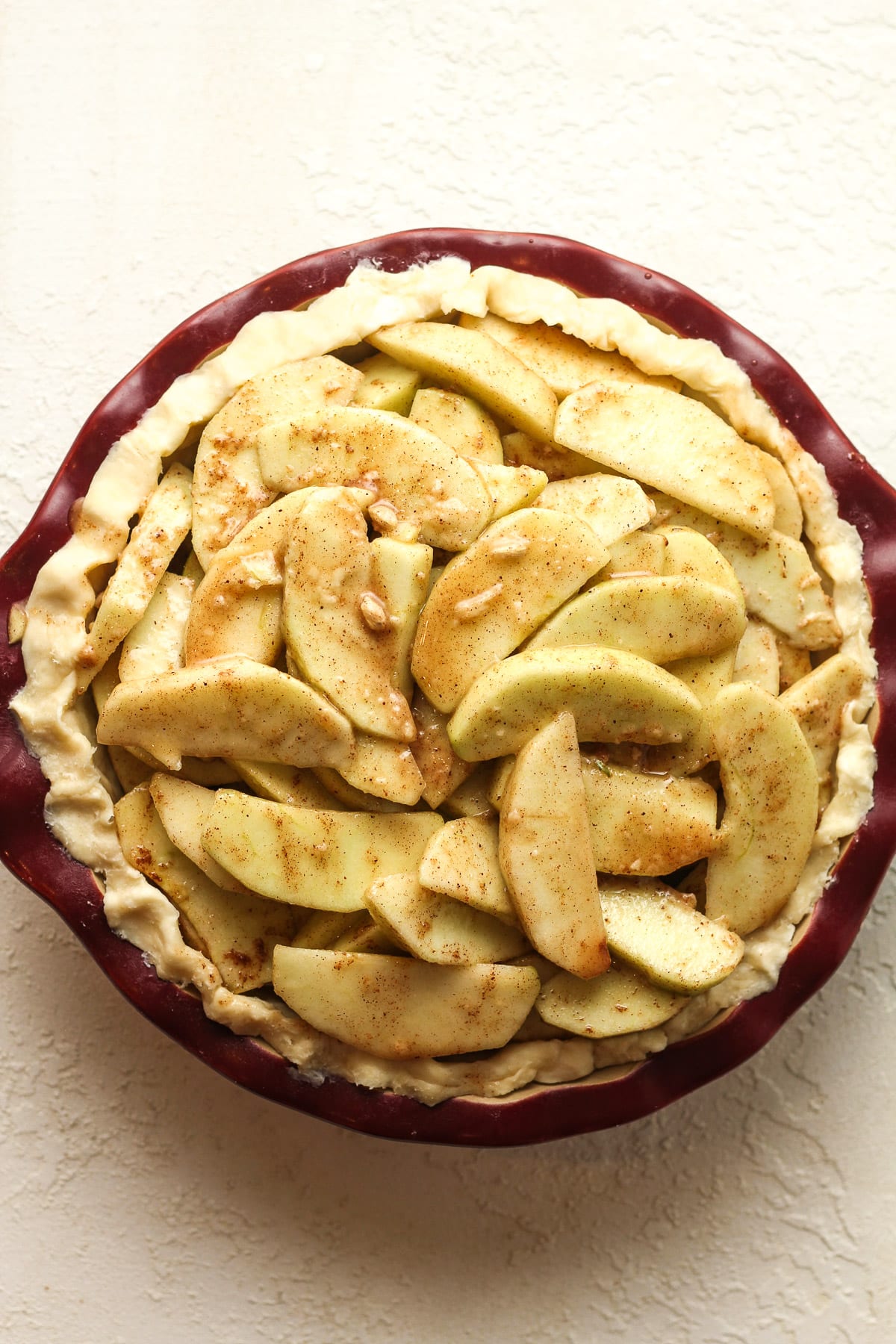 The pie after adding the apples.