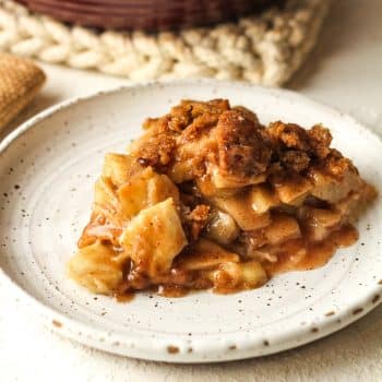 Side view of a slice of apple crumble pie.
