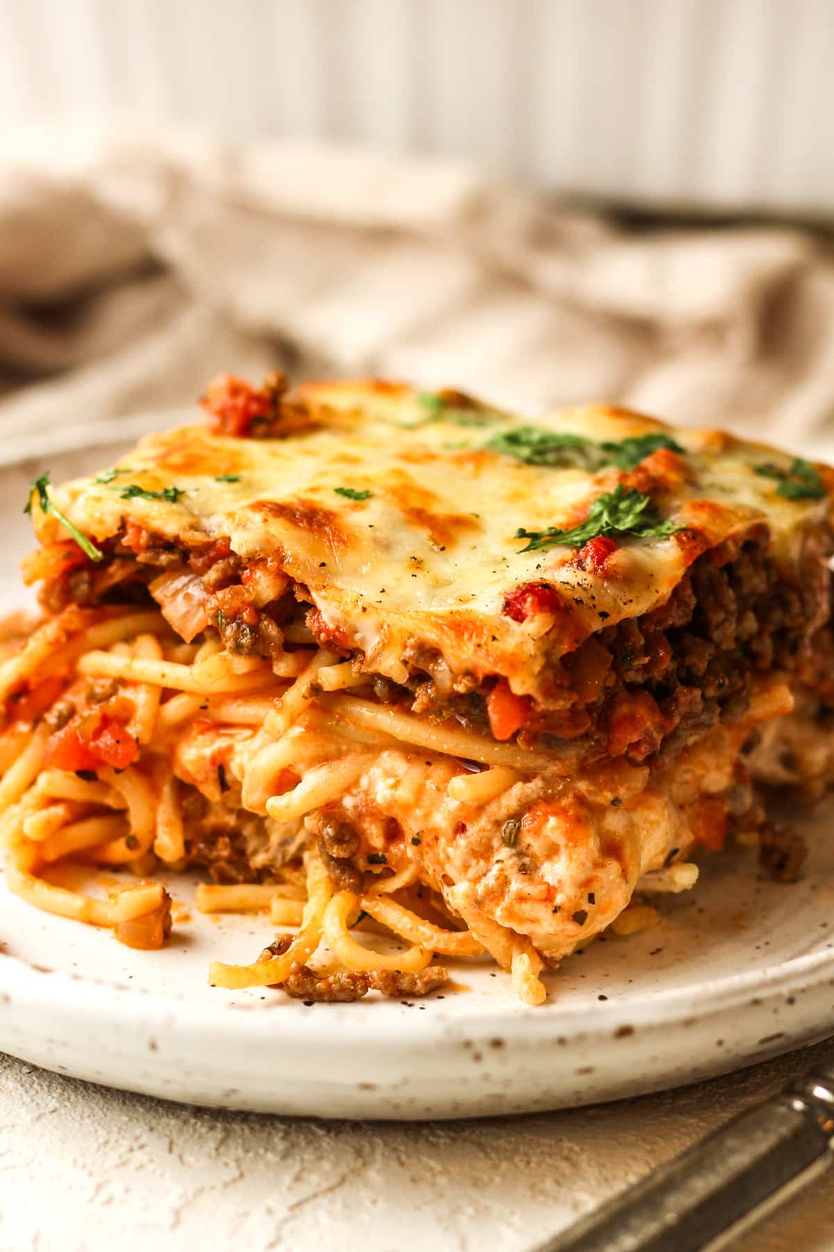 Closeup on a side view of a slice of spaghetti casserole.