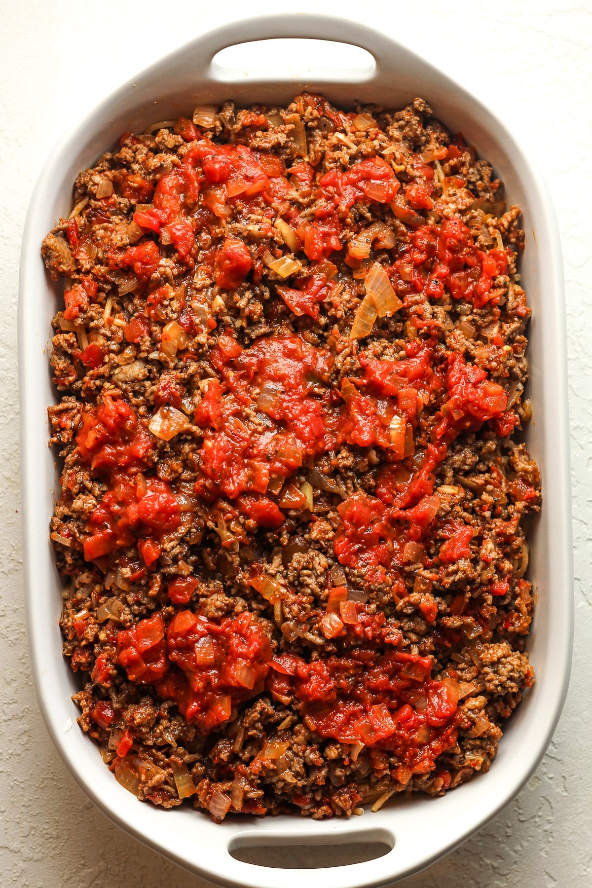 A casserole after adding the meat sauce.