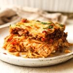 Side view of a square of baked spaghetti casserole.