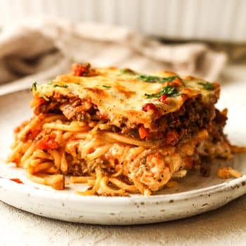 Side view of a square of baked spaghetti casserole.