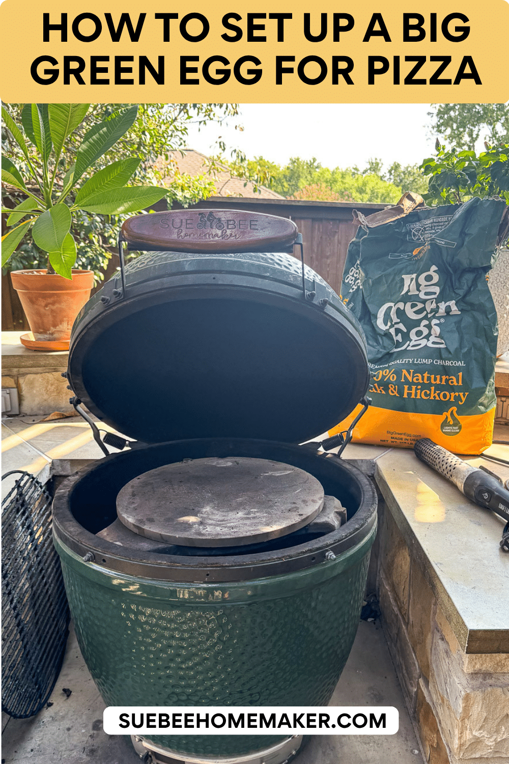 A Big Green Egg set up for pizza with a bag of charcoal in the background.