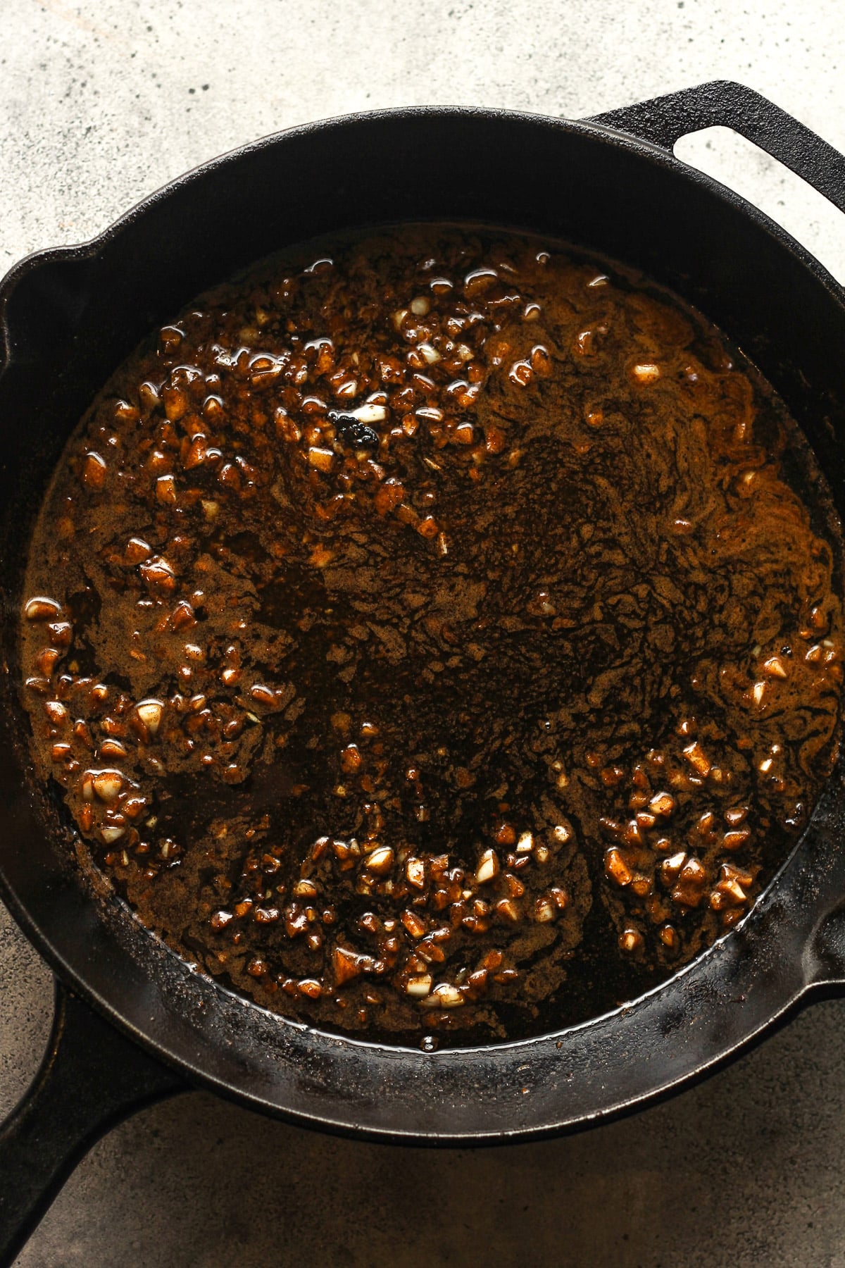 The skillet with the garlic butter plus Worcestershire sauce.