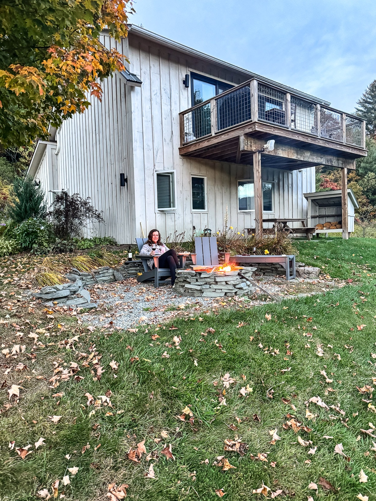 A view of the back of our airbnb with me sitting by the firepit.