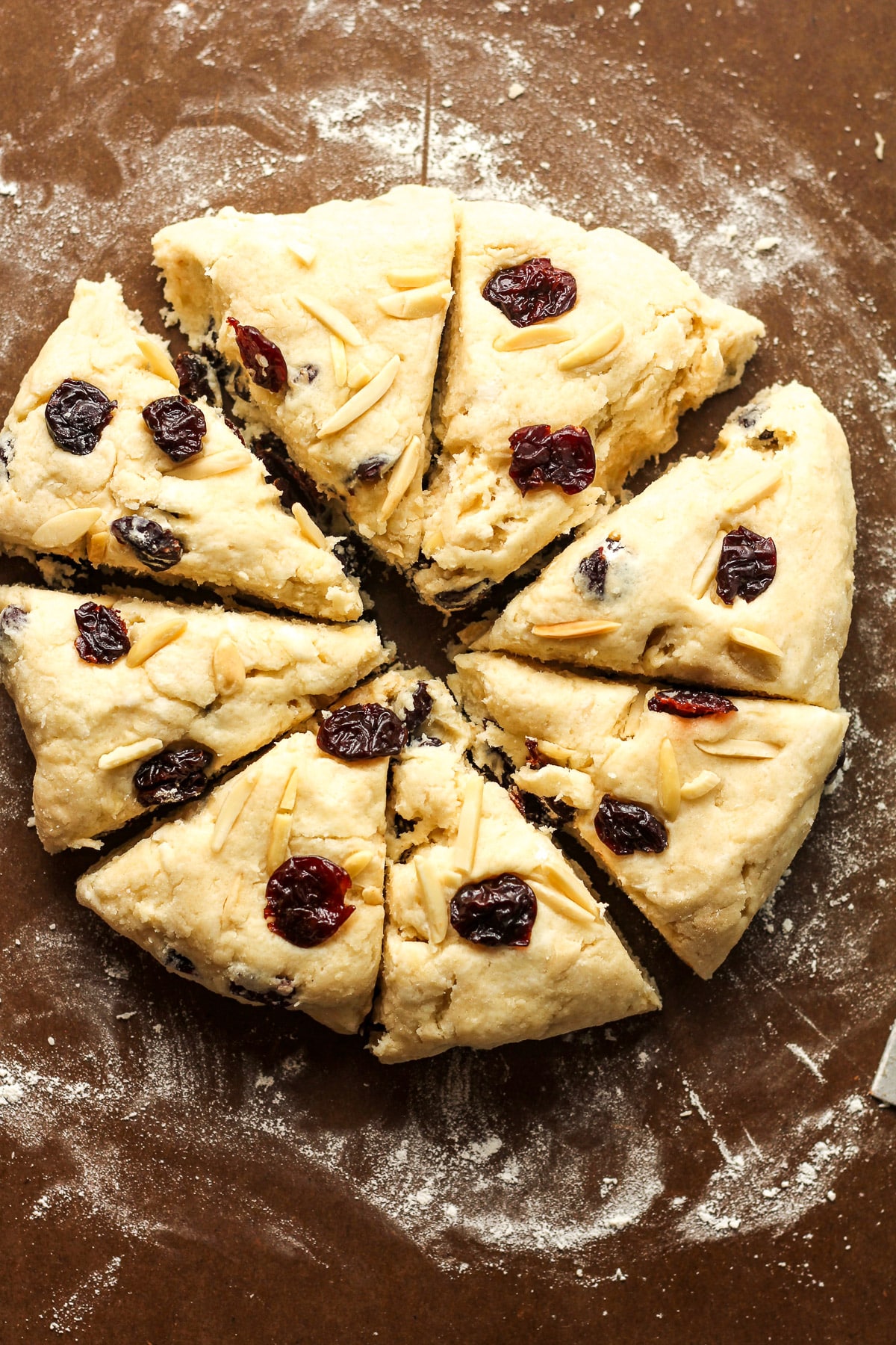 A board of the round dough sliced into eight triangles.