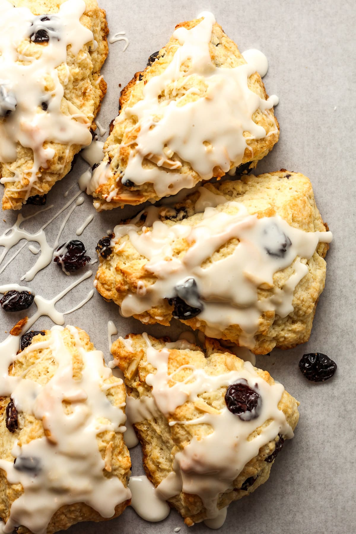 Closeup on some cherry almond scones with icing.