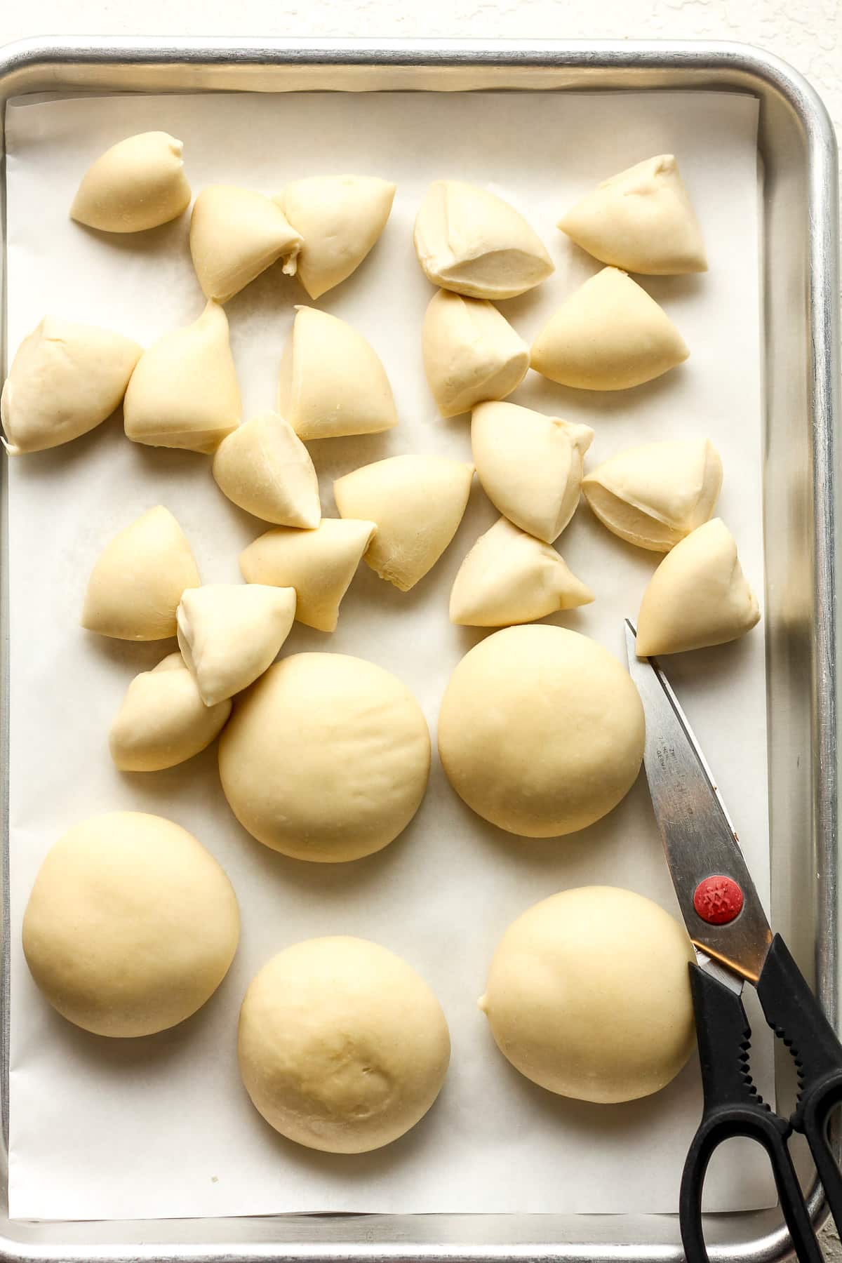 A pan of the Rhodes dough with some of the quartered.