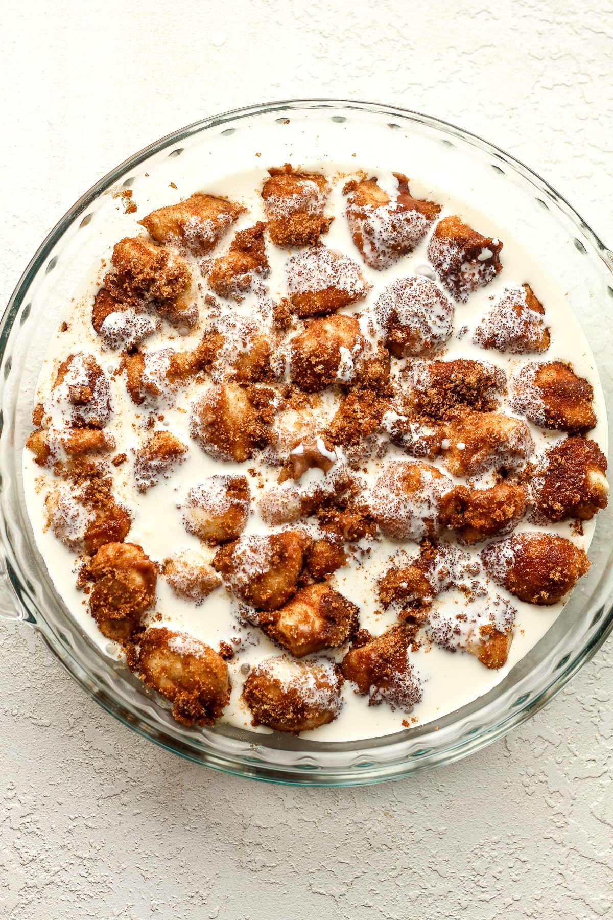 The dish of the dough bites with heavy cream on top.
