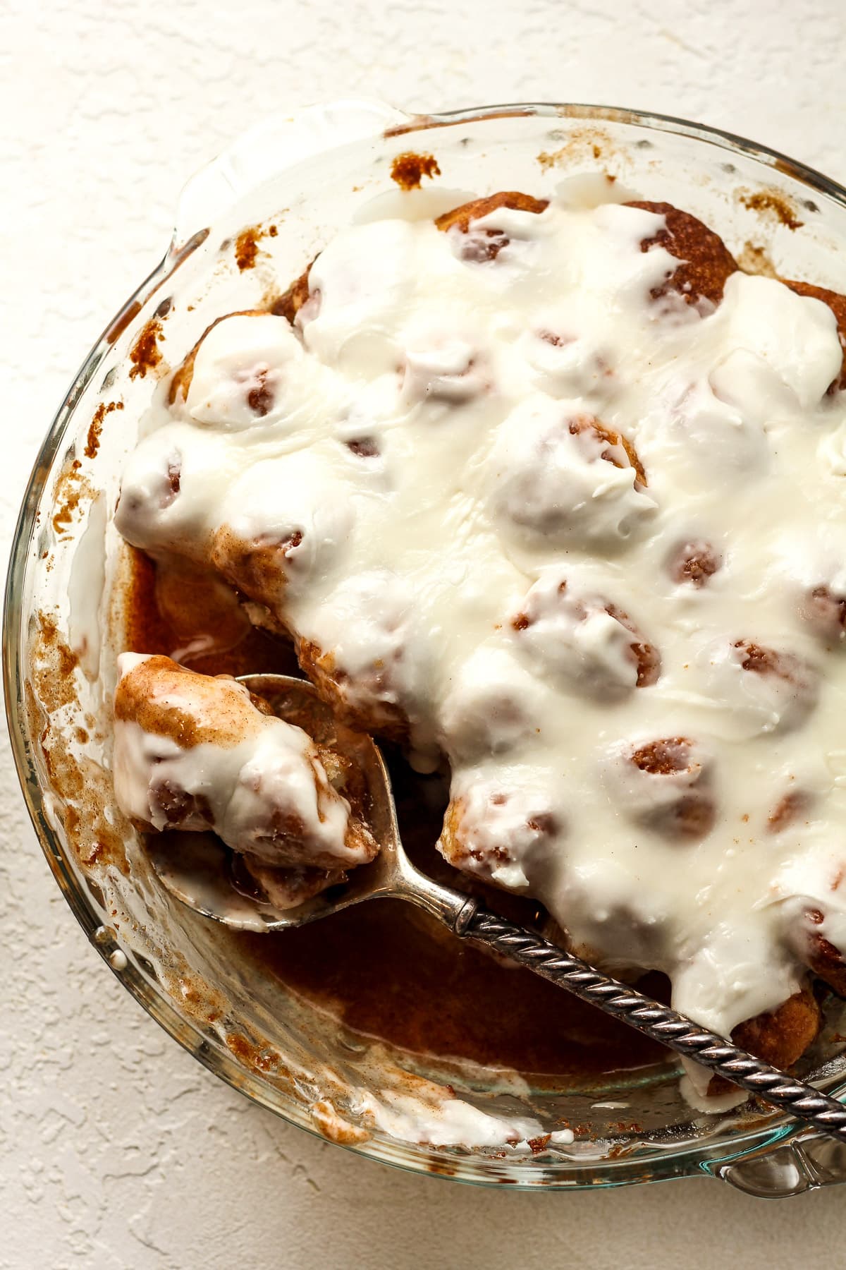 Overhead view of the dish of bites with a gray spoon.