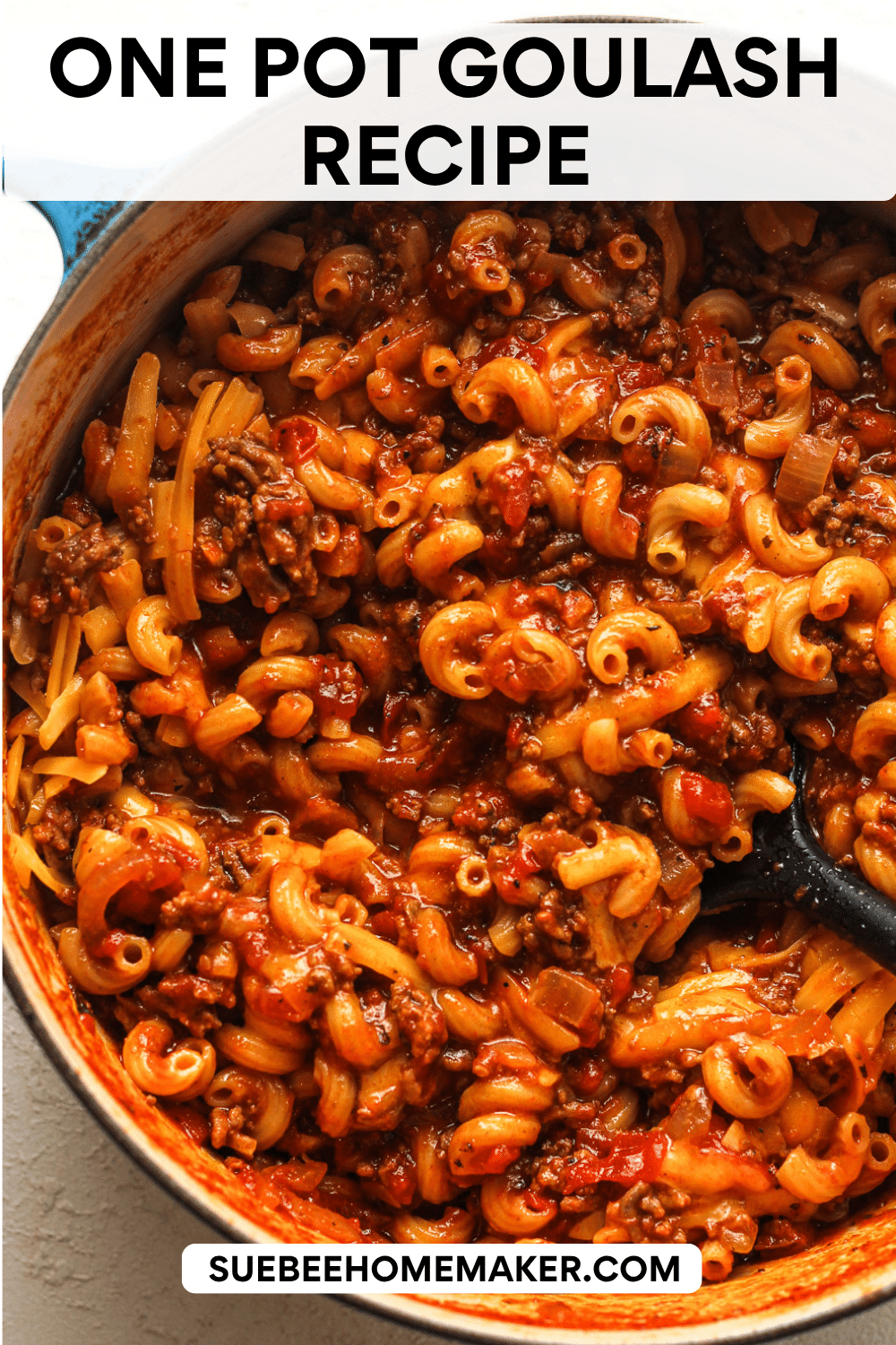 A pot of one pot goulash with cheese added in.